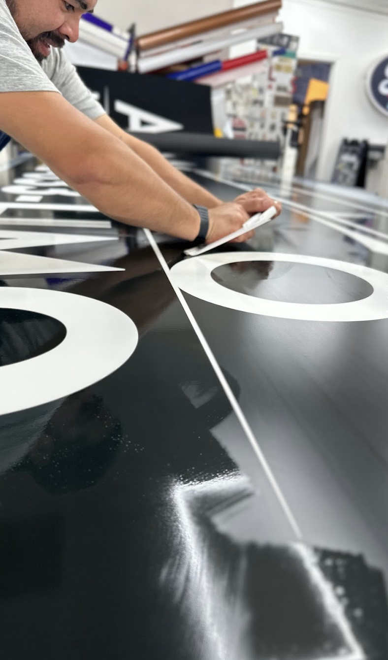 employee working on outdoor signage